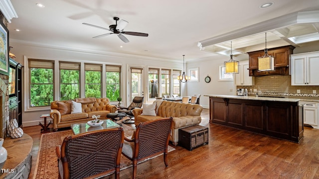 living room featuring dark wood-style floors, ceiling fan, ornamental molding, recessed lighting, and baseboards