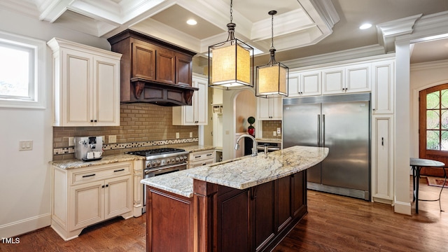 kitchen with high end appliances, a sink, crown molding, dark wood-type flooring, and coffered ceiling