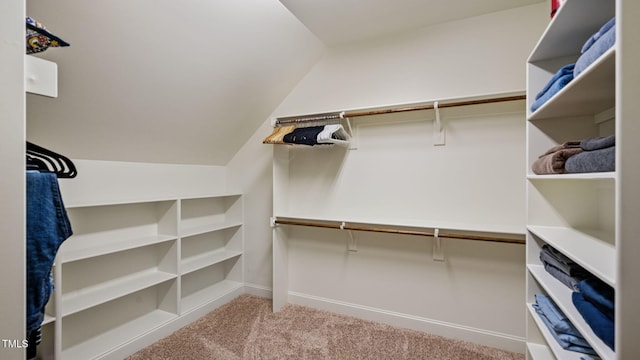 walk in closet featuring carpet flooring and lofted ceiling