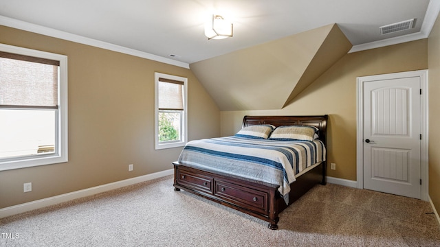 carpeted bedroom with baseboards, lofted ceiling, and ornamental molding