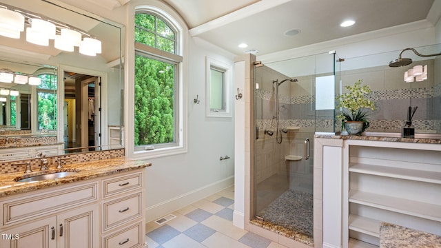bathroom with baseboards, a shower stall, decorative backsplash, vanity, and tile patterned floors