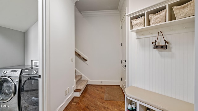 washroom featuring separate washer and dryer, crown molding, wood finished floors, and baseboards