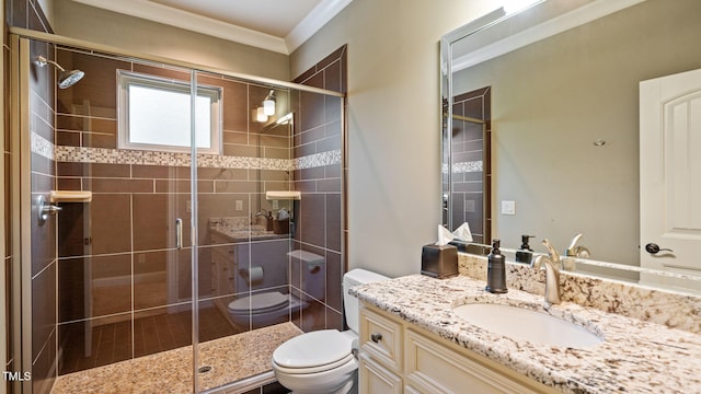 bathroom with toilet, ornamental molding, a shower stall, and vanity