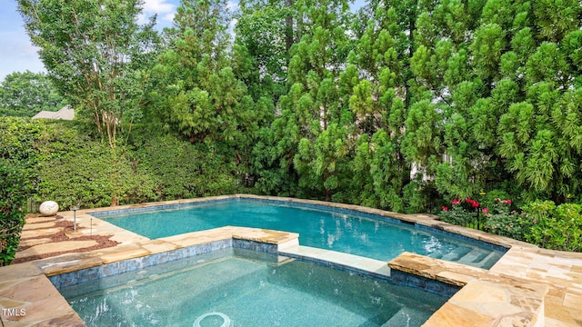 view of swimming pool featuring a pool with connected hot tub