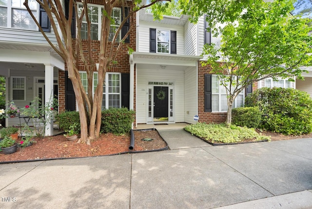 entrance to property featuring brick siding