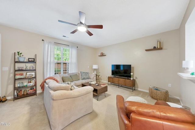 living room with visible vents, ceiling fan, light carpet, and baseboards