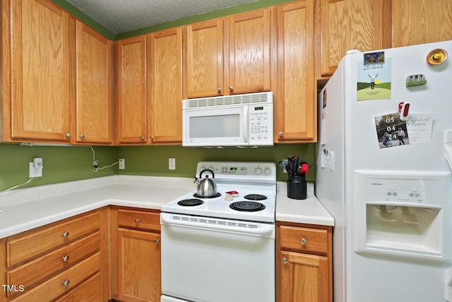 kitchen featuring white appliances and light countertops