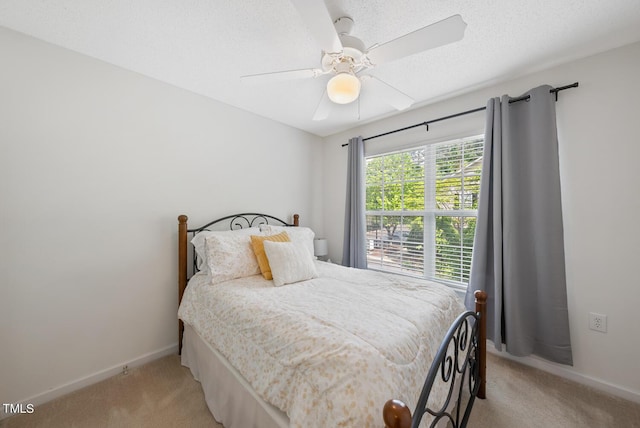 bedroom with baseboards, ceiling fan, and light colored carpet