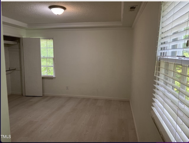 7412 Barberry Ct, Raleigh, NC 27615 - unfurnished bedroom with crown molding, light wood finished floors, a textured ceiling, a closet, and baseboards