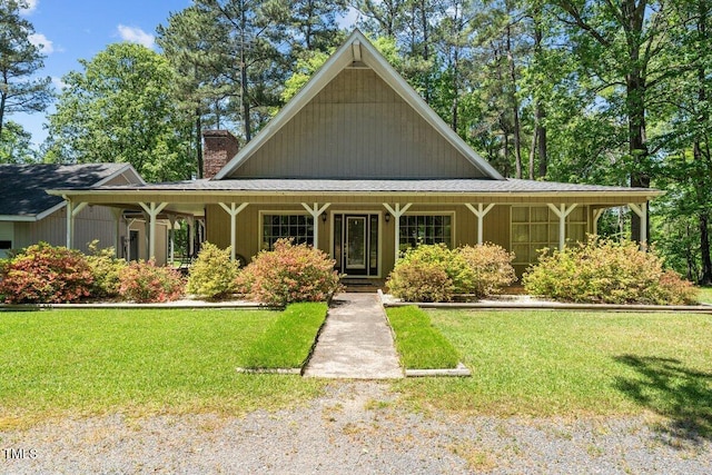 view of front of house with a front lawn and a chimney