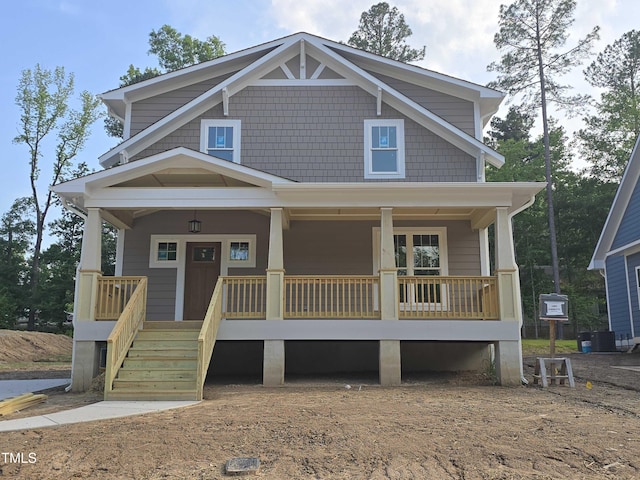 craftsman-style home with a porch and cooling unit