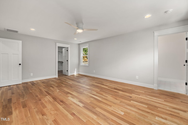 1005 Forrestal Pl, Durham, NC 27707 - unfurnished bedroom featuring a walk in closet, light wood-type flooring, a closet, recessed lighting, and a ceiling fan