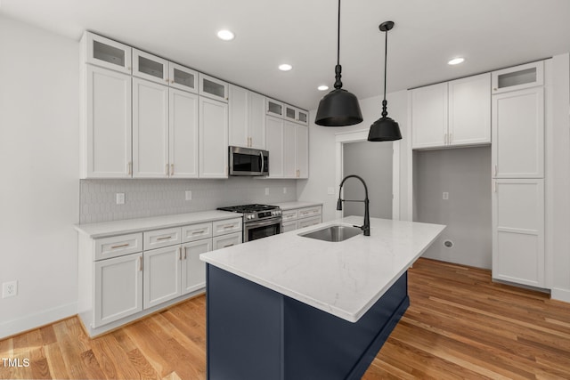 1005 Forrestal Pl, Durham, NC 27707 - kitchen with appliances with stainless steel finishes, white cabinets, a center island with sink, light wood-style flooring, and recessed lighting