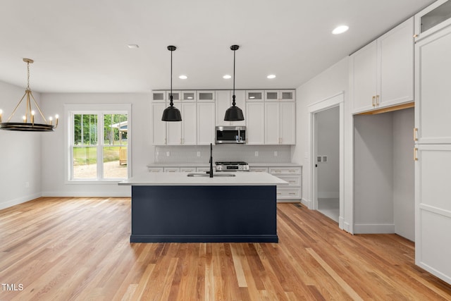 1005 Forrestal Pl, Durham, NC 27707 - kitchen with stainless steel microwave, a chandelier, light countertops, white cabinetry, and recessed lighting