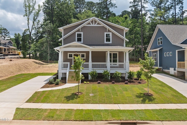1005 Forrestal Pl, Durham, NC 27707 - craftsman inspired home featuring covered porch, a front lawn, and view of scattered trees