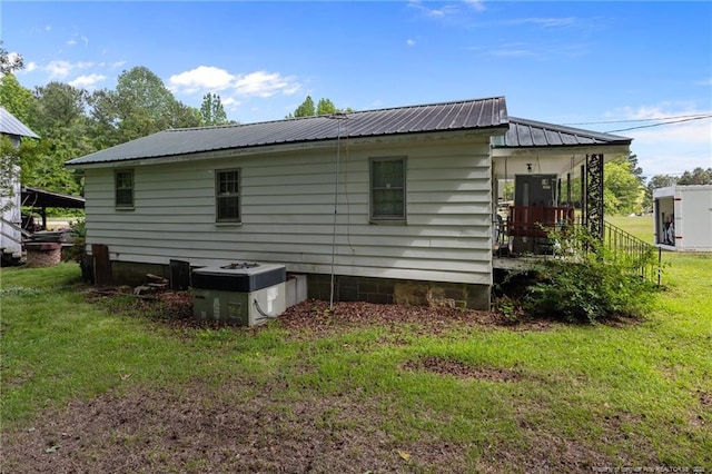 3042 Overhills Rd, Bunnlevel, NC 28323 - view of home's exterior featuring a lawn, metal roof, and cooling unit
