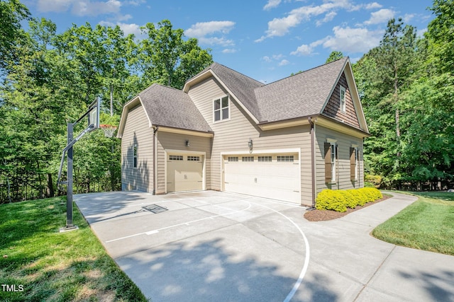 view of side of property featuring a shingled roof, driveway, an attached garage, and a lawn