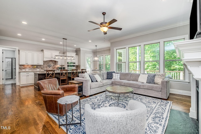 living area featuring plenty of natural light, dark wood-style flooring, a fireplace, and a ceiling fan