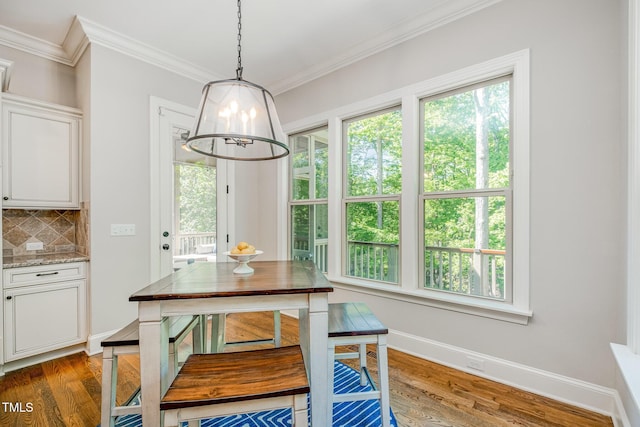 dining area featuring crown molding, a wealth of natural light, and wood finished floors