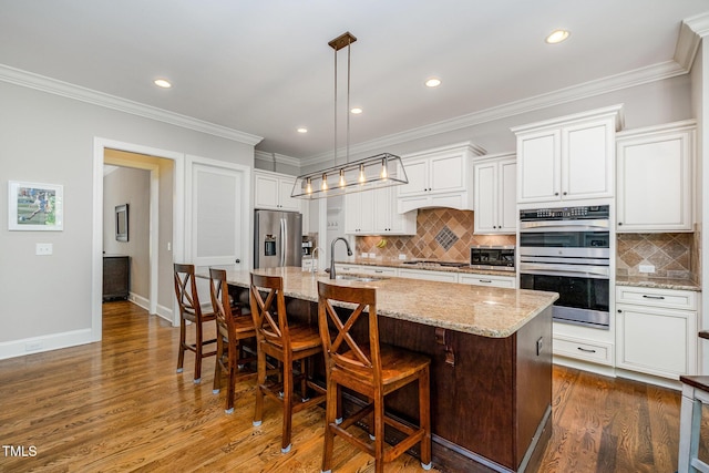 kitchen featuring dark wood-style flooring, stainless steel appliances, white cabinets, and a sink