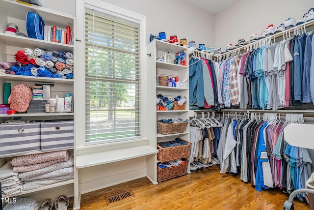 spacious closet featuring visible vents and wood finished floors