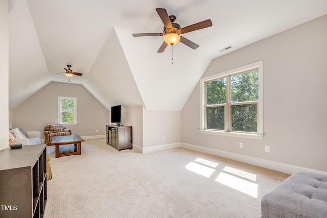 interior space featuring vaulted ceiling, baseboards, a ceiling fan, and visible vents