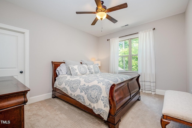 bedroom with light colored carpet, baseboards, a ceiling fan, and visible vents