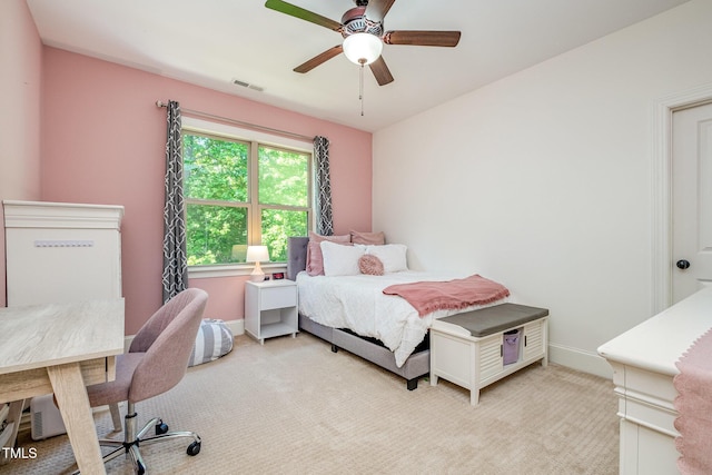 bedroom with baseboards, ceiling fan, light carpet, and visible vents