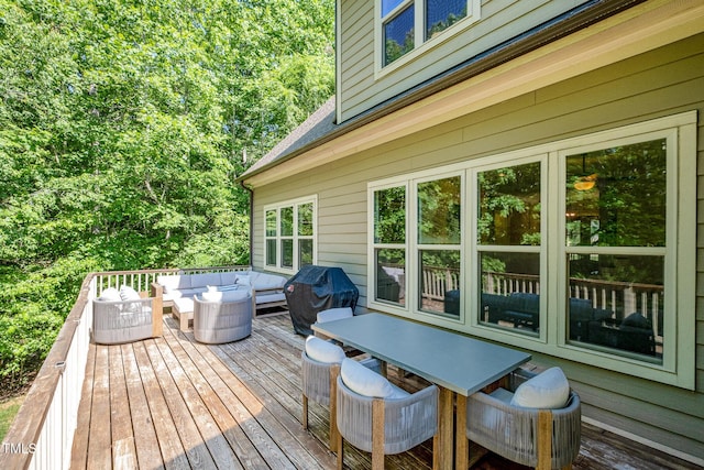 wooden terrace with an outdoor hangout area and outdoor dining space