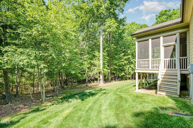 view of yard featuring stairs and a sunroom
