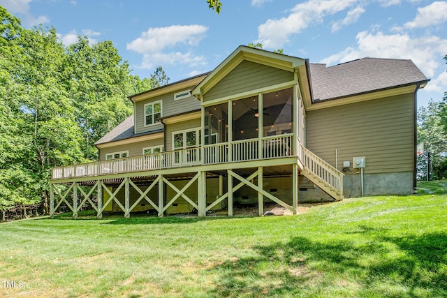 back of property featuring a sunroom, a shingled roof, a yard, and ceiling fan
