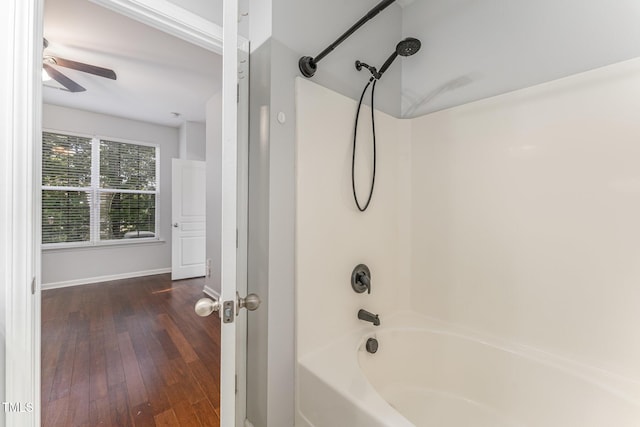 full bathroom with baseboards, ceiling fan, hardwood / wood-style floors, and bathing tub / shower combination