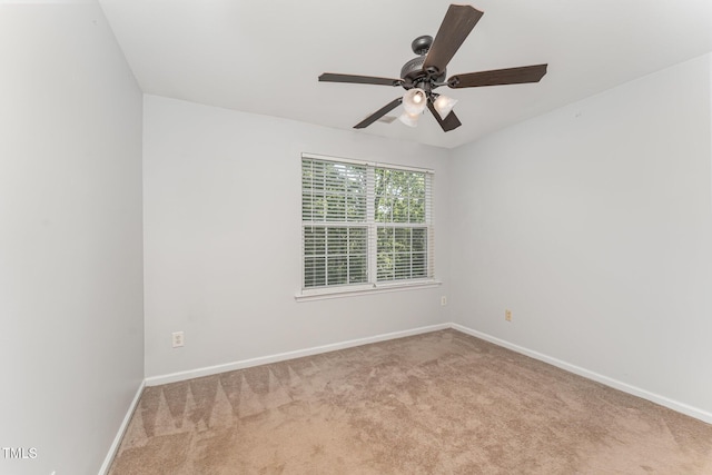 unfurnished room with baseboards, carpet flooring, and a ceiling fan