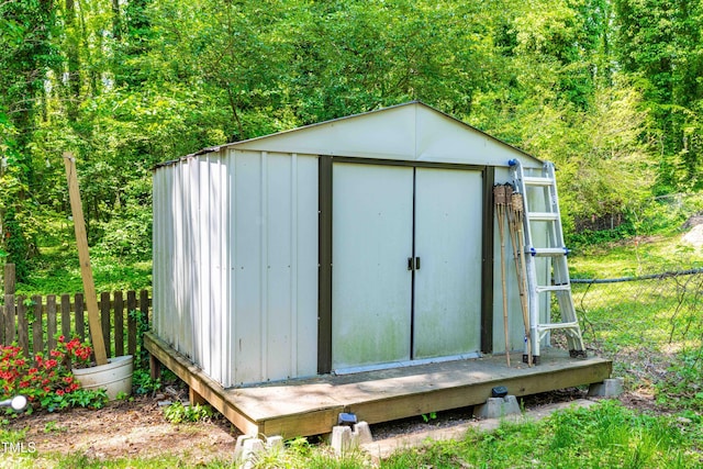 7313 Longstreet Dr, Raleigh, NC 27615 - view of shed featuring a wooded view and fence