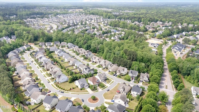 birds eye view of property featuring a forest view and a residential view