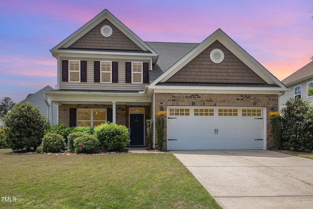 traditional-style home with an attached garage, driveway, brick siding, and a yard