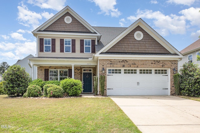 craftsman inspired home with concrete driveway, an attached garage, brick siding, and a front yard
