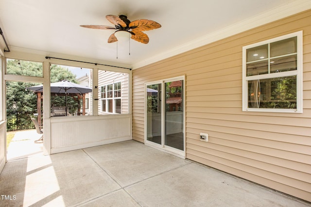 unfurnished sunroom with a ceiling fan