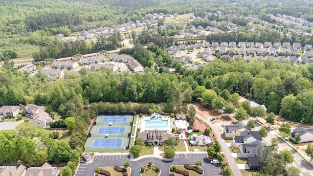 birds eye view of property with a view of trees and a residential view