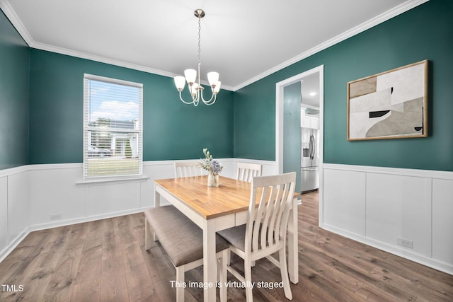 214 Thumper Way, Clayton, NC 27520 - dining room featuring crown molding, wood finished floors, a wainscoted wall, and a chandelier
