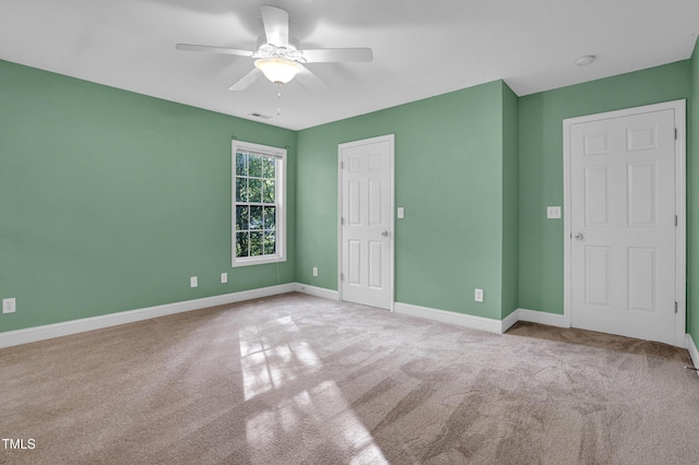 unfurnished bedroom featuring visible vents, ceiling fan, carpet flooring, and baseboards