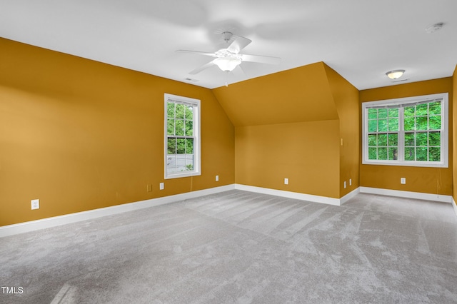 bonus room with a ceiling fan, baseboards, vaulted ceiling, and carpet floors