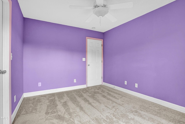 empty room featuring ceiling fan, carpet flooring, and baseboards