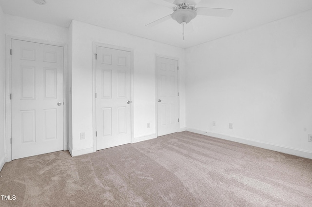 unfurnished bedroom with baseboards, ceiling fan, and carpet