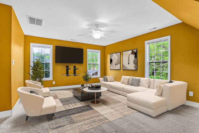 carpeted living room featuring baseboards, visible vents, and ceiling fan