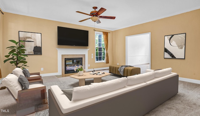 living room with carpet flooring, a fireplace, crown molding, a ceiling fan, and baseboards