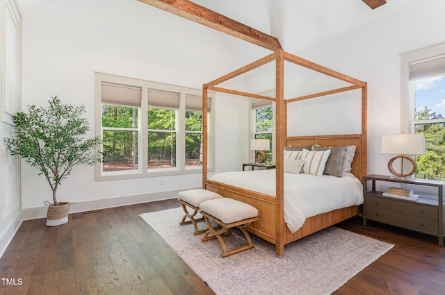 bedroom featuring baseboards and dark wood-type flooring