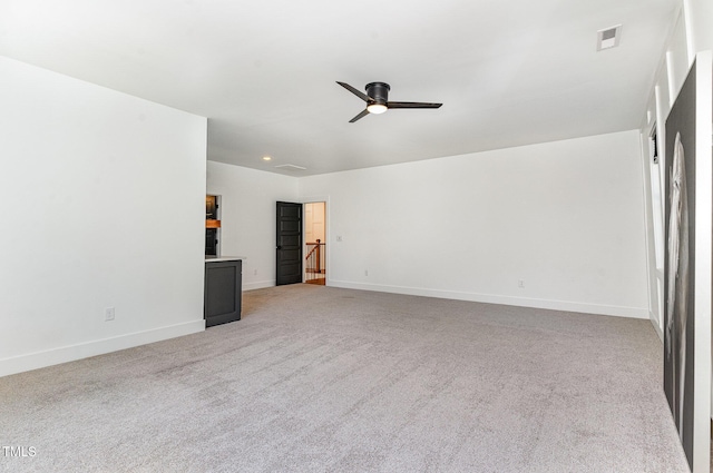 unfurnished room featuring ceiling fan, visible vents, light colored carpet, baseboards, and recessed lighting