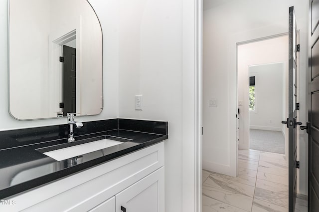 bathroom featuring baseboards, vanity, and marble finish floor