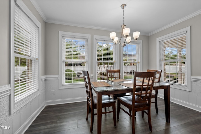 dining area with baseboards, ornamental molding, dark wood-style flooring, and a chandelier